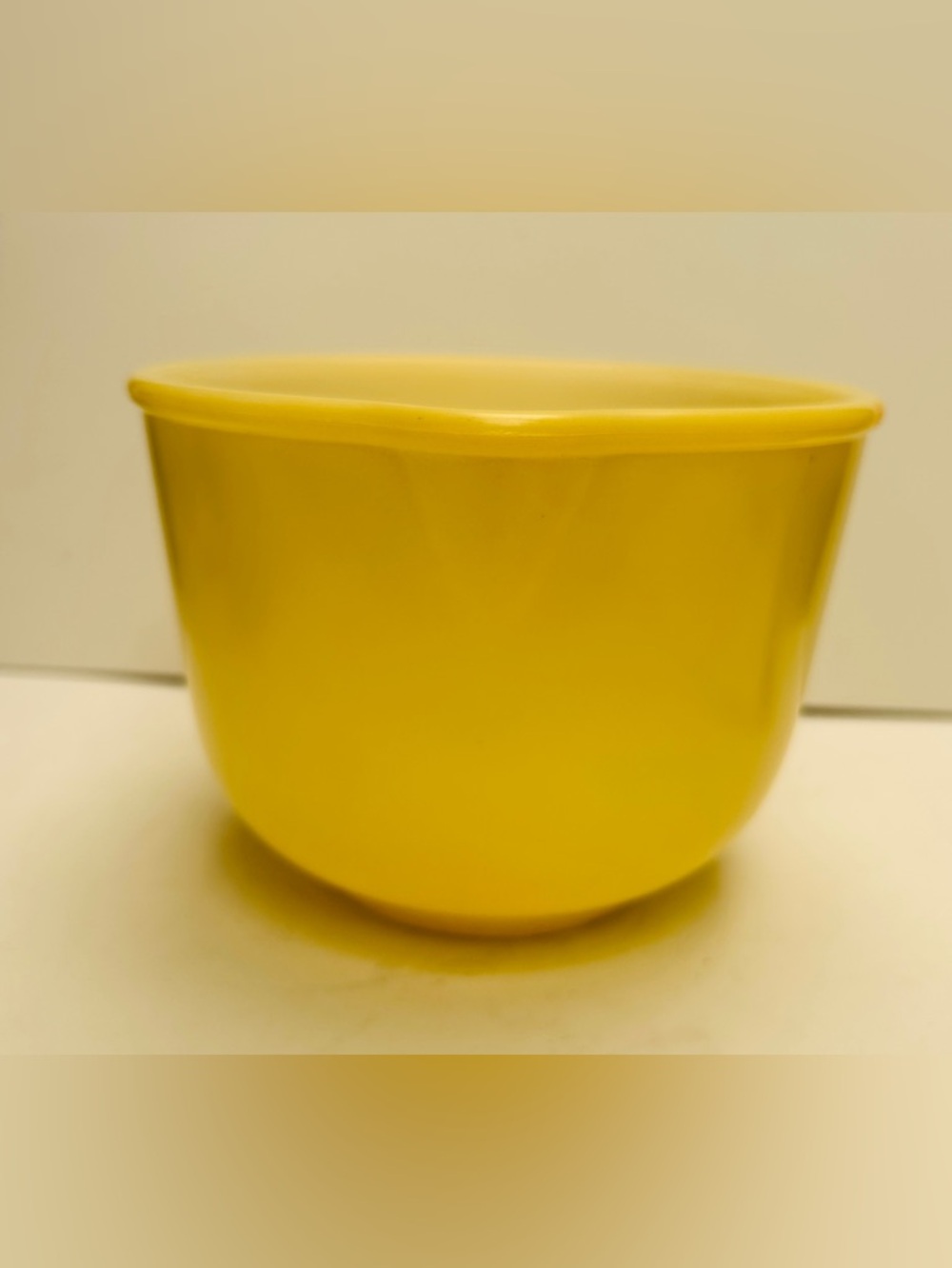 Vintage Glasbake bowl by Sunbeam. Pale yellow color.